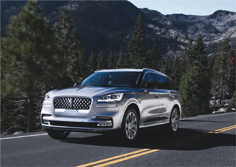 A 2023 Lincoln Aviator® Grand Touring SUV being driven on a winding road to demonstrate the capabilities of all-wheel drive | Sheehy Lincoln of Richmond in Richmond VA